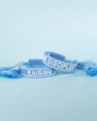 Raising Disciples Blue & White Embroidered Bracelet with Gold Charm